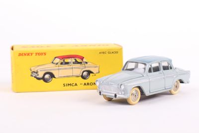 a small toy car sitting next to a yellow box