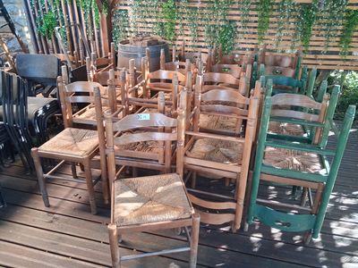 a lot of chairs that are sitting on a wooden deck