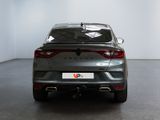 the rear end of a grey car in a white room