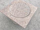 une plaque de regard posée à même la chaussée