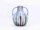 a blue and white vase sitting on a white surface