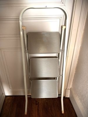 a ladder that is leaning against a wall in a room