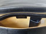 a close up of a black purse with a gold zipper