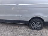 a van that has been vandalized and is parked on the side of the road