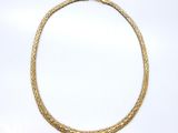 a gold necklace on a white background