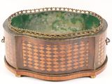 a green and brown bowl sitting on top of a table