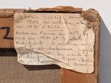 a piece of paper taped to a piece of wood with writing on it