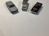 three toy cars that are sitting on a table