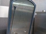 a stainless steel trash can with a handle in a kitchen