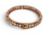 a close up of a gold ring with diamonds on a white background
