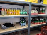 many bottles of soda on the shelves in the store