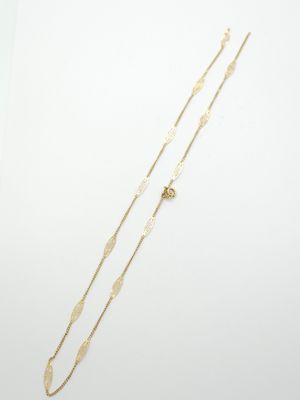 a gold necklace and a gold bracelet on a white background