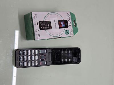 a remote control sitting next to a box on a table