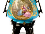 a blue vase with a painting on it sitting on a stand