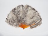 a hair brush and a comb on top of a piece of fur