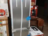 a refrigerator and a refrigerator freezer in the middle of a room
