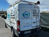 a white van that is parked on the side of the road