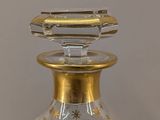 a glass vase with a gold star design on it