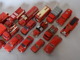 a lot of red toy trucks that are on a table