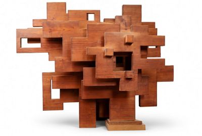 a sculpture made of wooden blocks on a white surface