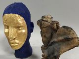 three sculptures of a man ' s head and a woman ' s head