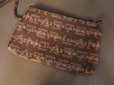 a small purse with a wrist strap on a table