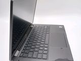 a black laptop with a black keyboard on a white surface