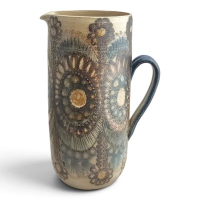 a blue and white pitcher with a pattern on it