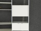 a picture of a white book shelf with drawers and a ladder