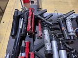many different types of guns that are on the table