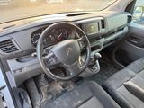 a dashboard and steering wheel of a car in a parking lot