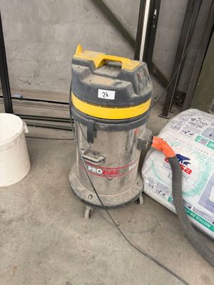 a vacuum and a bucket on the floor next to a window