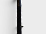 a close up of a metal object on a white wall