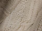 a close up of a white knitted sweater