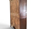 an old wooden armoire with a door on top of it