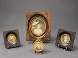 three miniature portraits of a woman and a man in a wooden frame