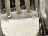 two forks sitting next to each other on a table