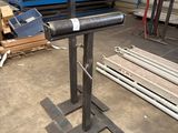 an image of a metal pipe on a stand in a warehouse