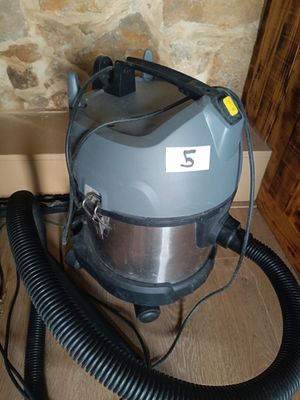 a vacuum that is sitting on the floor next to a wall
