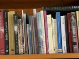 many books that are on a book shelf together