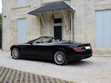 a black convertible car parked in front of a building