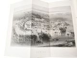 an open book with a picture of a city on it