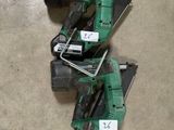 two electric tools are sitting on the floor next to a pair of orange cones
