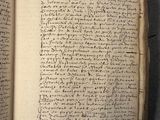 an open book with writing on it sitting on top of a table