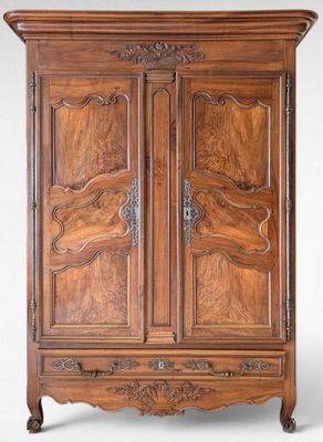an antique wooden armoire with carvings on the doors and drawers