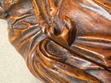 a wooden statue of a man with a hat and a cane