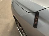 a sticker on the hood of a silver car