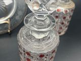 three glass jars sitting next to each other on a table