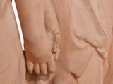 statue of a woman holding a child ' s hand on a white background