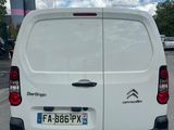 the back of a white van parked in a parking lot